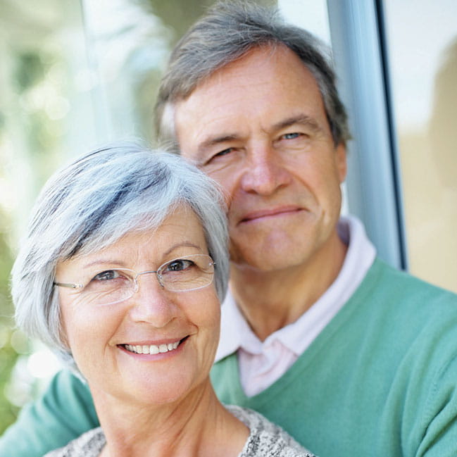 woman and man smiling and looking at camera