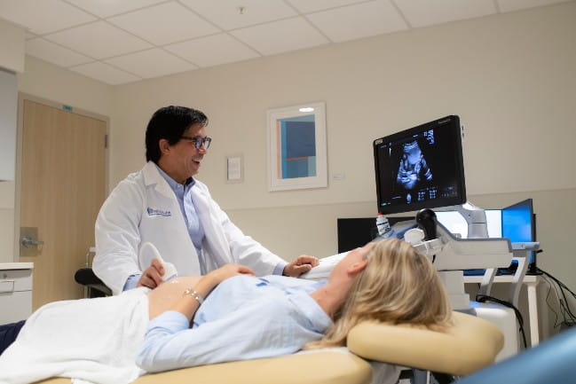 Dr. Chang with patient during ultrasound.