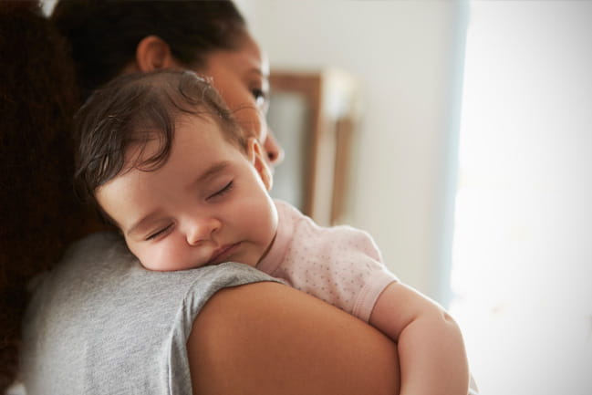 a mother holding a baby