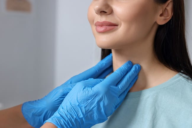 woman getting her neck examined