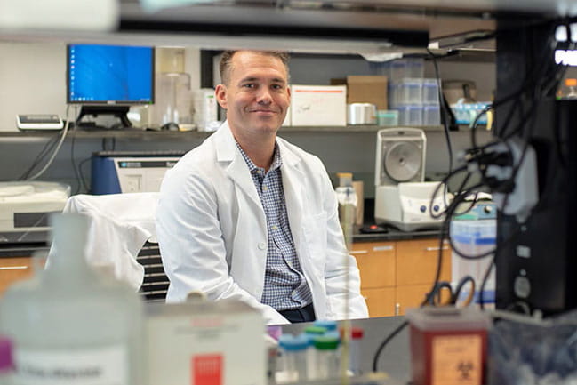 Nate Dolloff sits in his lab.