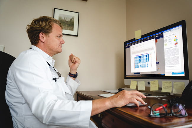  Dr. John Wrangle looks at his computer screen.  