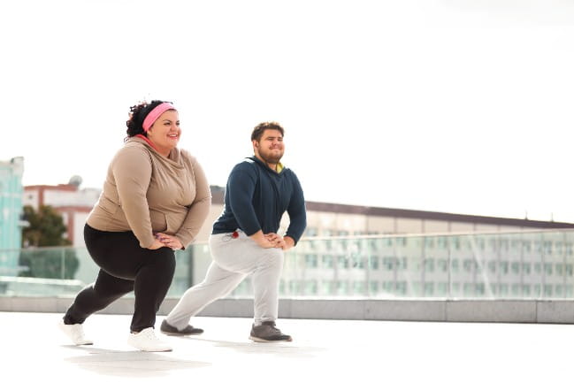 Two people stretching.