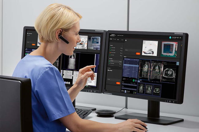 a technician looks at an MRI scan