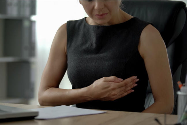 Image of woman examining her own breast.