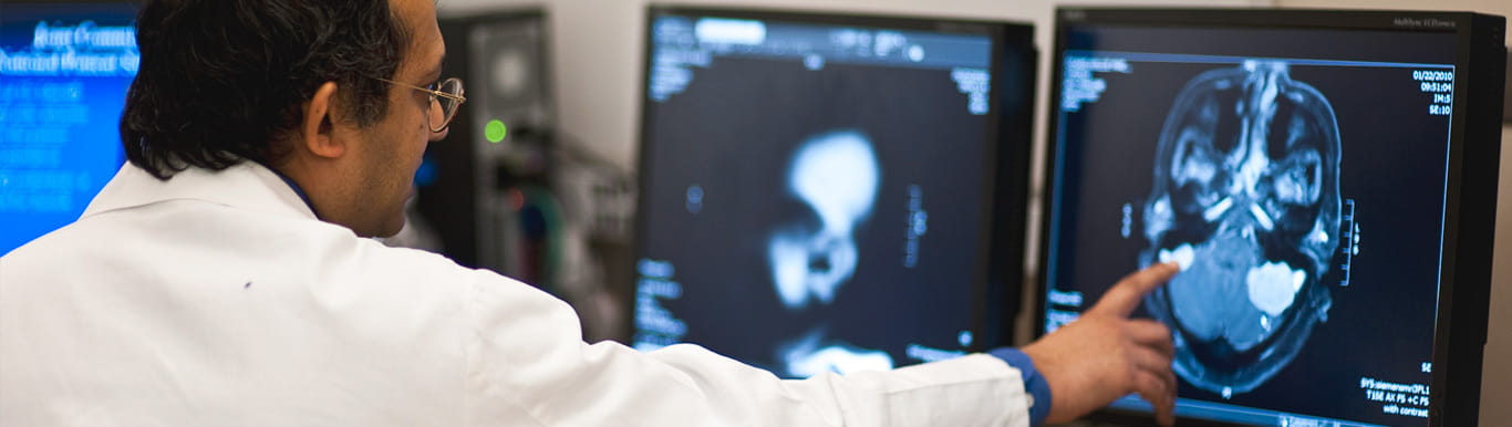 Sunil Patel, M.D., looks at a scan of the brain. 