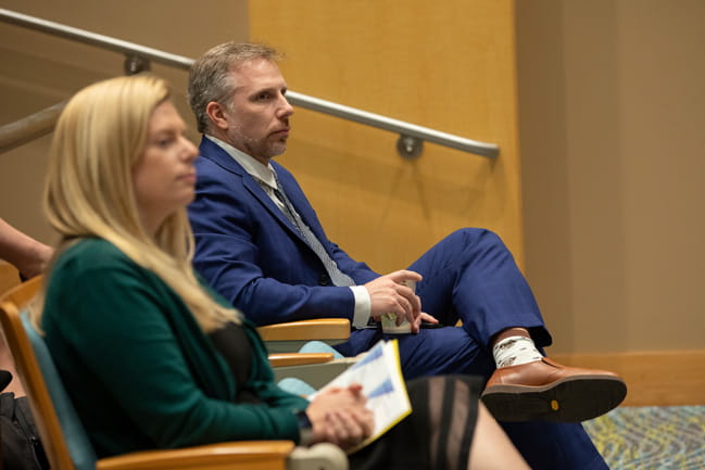 Dr. Lori McMahon listens to a lecture