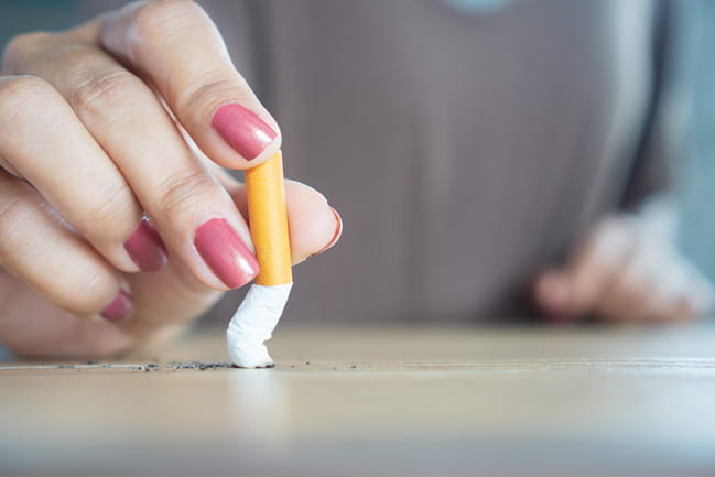 hand putting out cigarette