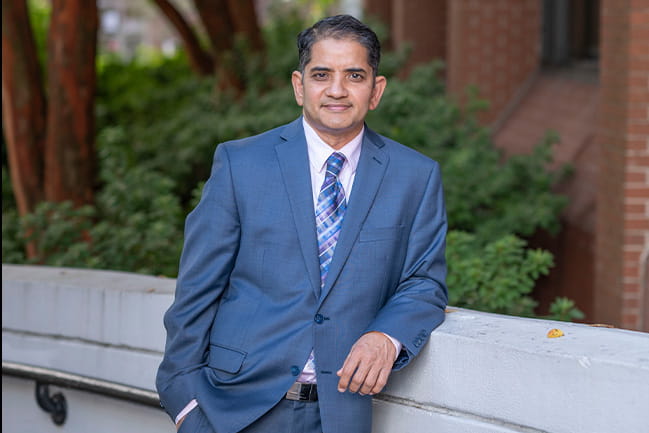 Physician stands outside in front of psychiatry building at MUSC.