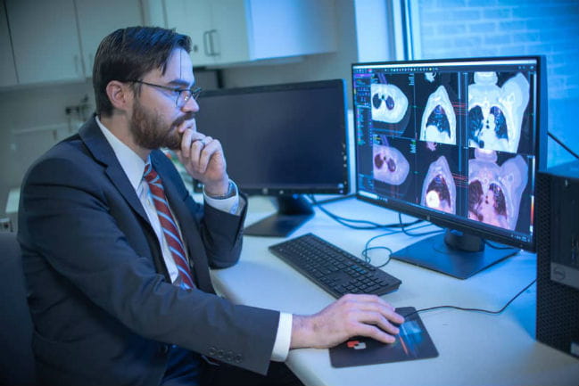 Image of Dr. Wooten studying images on a computer